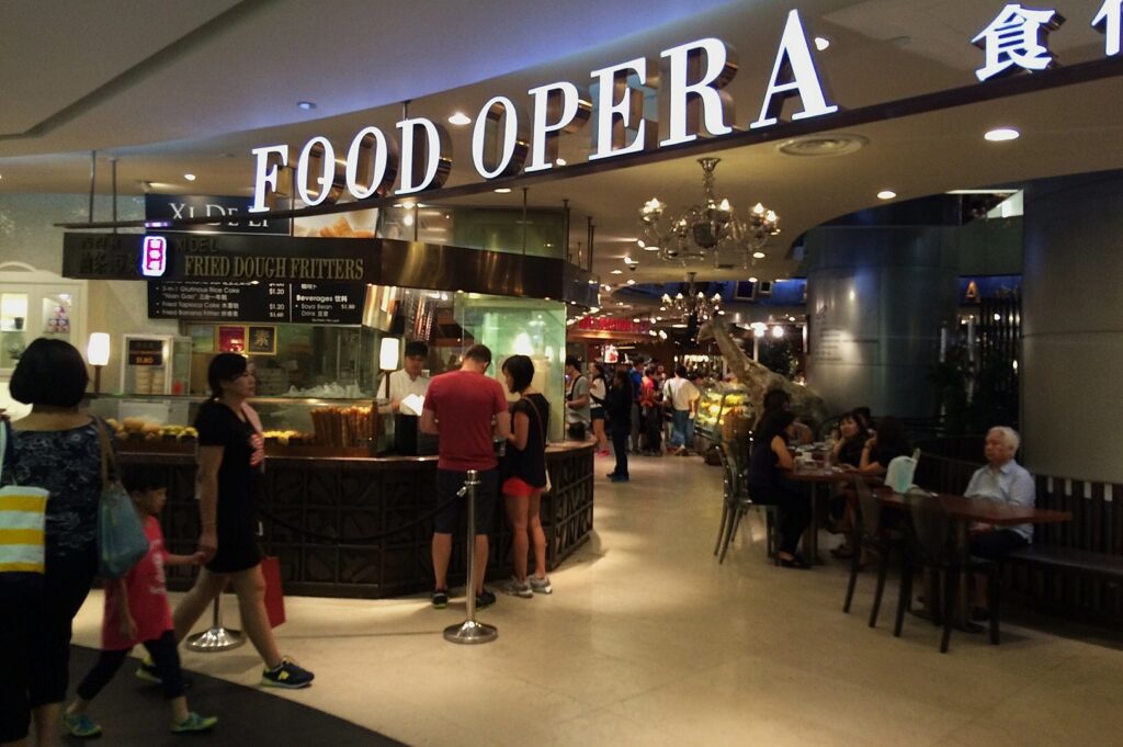The bustling Ion Orchard Food Court, featuring a variety of delicious dishes in a lively atmosphere.