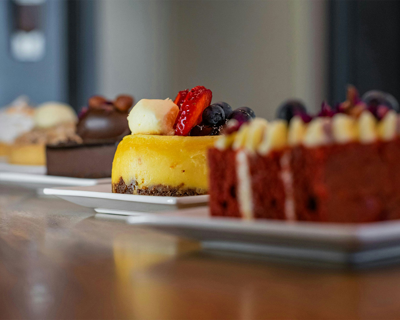 A neatly presented dessert served on a plate at a café table, with soft natural light and blurred background of the café interior.